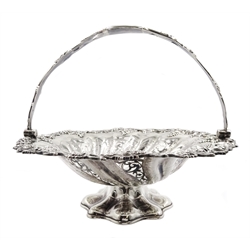 Victorian silver pedestal fruit basket with swing handle, applied vine and grape decorative border, pierced and engraved foliate body by Martin, Hall & Co, Sheffield 1857, approx 37.5oz, diameter 32.5cm