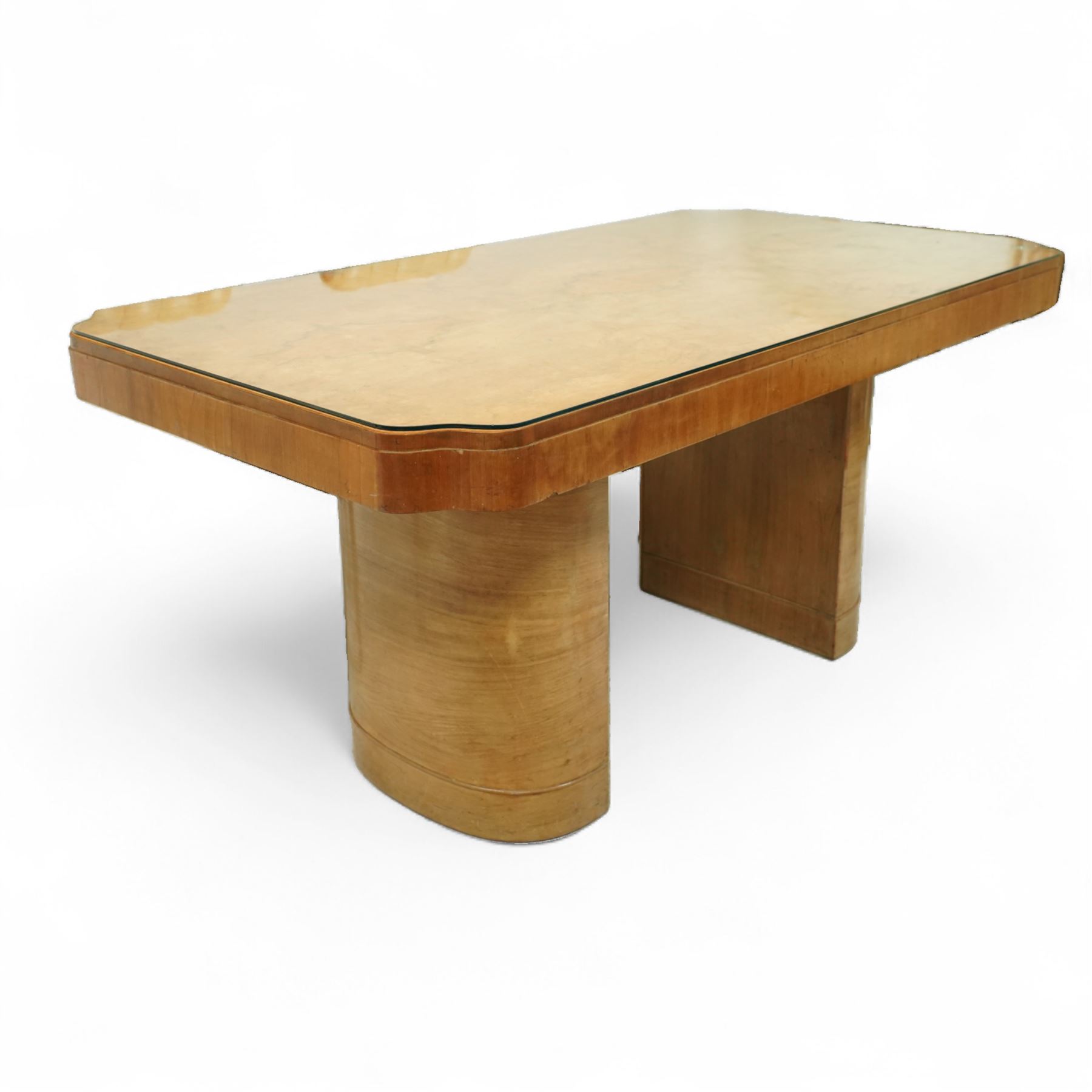 In the manner of Harry & Lou Epstein - Art Deco figured walnut veneered dining table, rectangular top with canted corners and glass protective top, edge with gently canted profile, on two rounded drum-shaped pedestals together with a set of four mid-century style walnut chairs, with elegant scroll and walnut veneered backs, upholstered in a light cream leather, 54x44x96cm