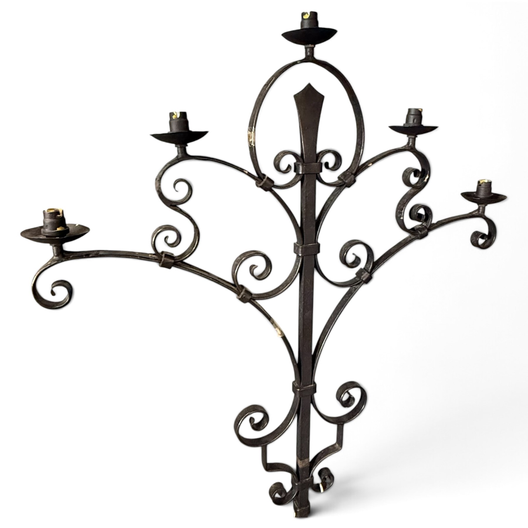 Collection of wrought iron candle stands, comprising five-light and three-light floor-standing candelabra with scrolling branches, and a pair of five-light table candelabra of naturalistic branching form