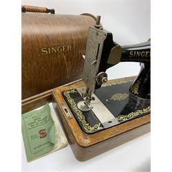 A cased Singer sewing machine, with instruction booklet and key. 