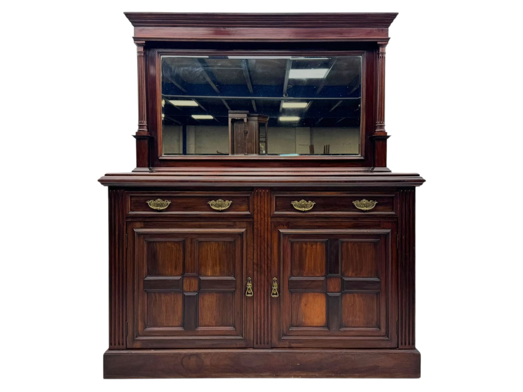 Victorian mirror back press, the arched corniced mirror back flanked by half columns, the base fitted with three drawers and four moulded panel doors with geometric detail, on a block plinth
