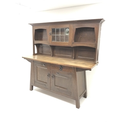  Early 20th century Arts & Crafts Leonard Wyburd for Liberty Design oak dresser fitted with single drawer and two cupboards, raised back with shelves either side of cupboard enclosed by lead glazed door, W203cm, H187cm, D62cm  