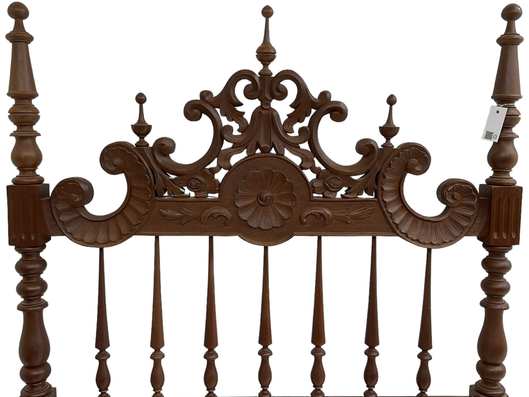 Pair of Spanish carved hardwood headboards, the pediment carved and pierced with shell C-scrolls and carved foliage, turned spindle back, on turned supports 