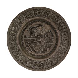 Set of four Persian silvered copper plates, decorated in relief, the central panel depicting figures in various scenes with a floral boarder, D17cm