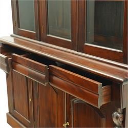 Victorian revival hardwood dresser, projecting moulded cornice above three glazed doors enclosing shelves, moulded top over three drawers and three panelled cupboard doors, flanked by applied carved scroll brackets, on plinth base,