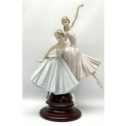 Lladro figure group, 'Merry Ballet', modelled as two ballerinas in dancing pose, raised on a turned socle base, no. 5035, printed marks beneath, H49cm