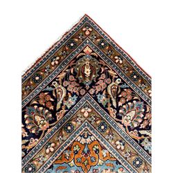 Persian Kashan peach ground rug, central rosette medallion surrounded by trailing branches and flower heads with bird motifs, light blue spandrels with further floral decoration, the main border with repeating palmettes and birds, within guard stripes