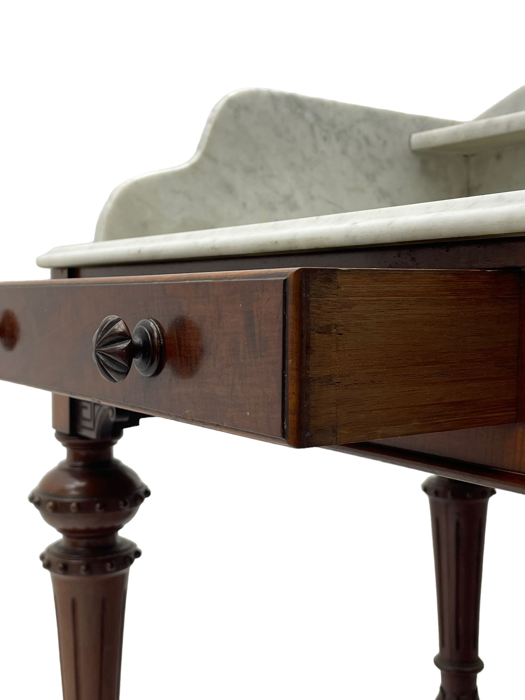 Victorian figured mahogany two-piece bedroom set - the washstand with white and black marble moulded top with arched back and raised shelf, two moulded frieze drawers, on turned and fluted supports with brass and ceramic castors (W123cm, D60cm, H102cm); the dressing table with raised swing mirror in moulded frame with shell and scroll carved pediment, on scrolled horns carved with foliage, four raised trinket drawers over moulded rectangular top, fitted with two drawers, on turned and fluted supports with brass and ceramic castors (W122cm, H177cm, D62cm)