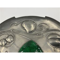 Liberty & Co Tudric pewter Bollelin tray, designed by Archibald Knox, of circular form with shaped edge, cast in relief with foliate tendrils surrounding a green enamel cartouche, impressed beneath Made by Library & Co English Pewter 044, D25.5cm