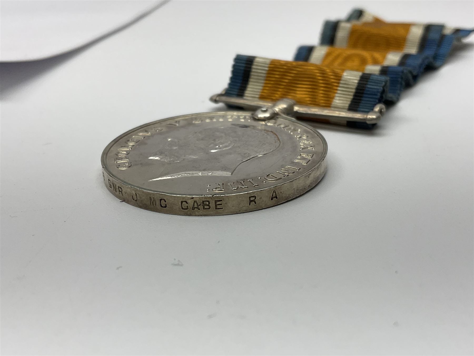 WW2 German Luftwaffe Mess cutlery comprising table spoon and fork, each with H.M.Z.38 mark; WW1 British War Medal awarded to L-13858 Gnr. J. McCabe R.A.; and small quantity of military badges, rank pips etc