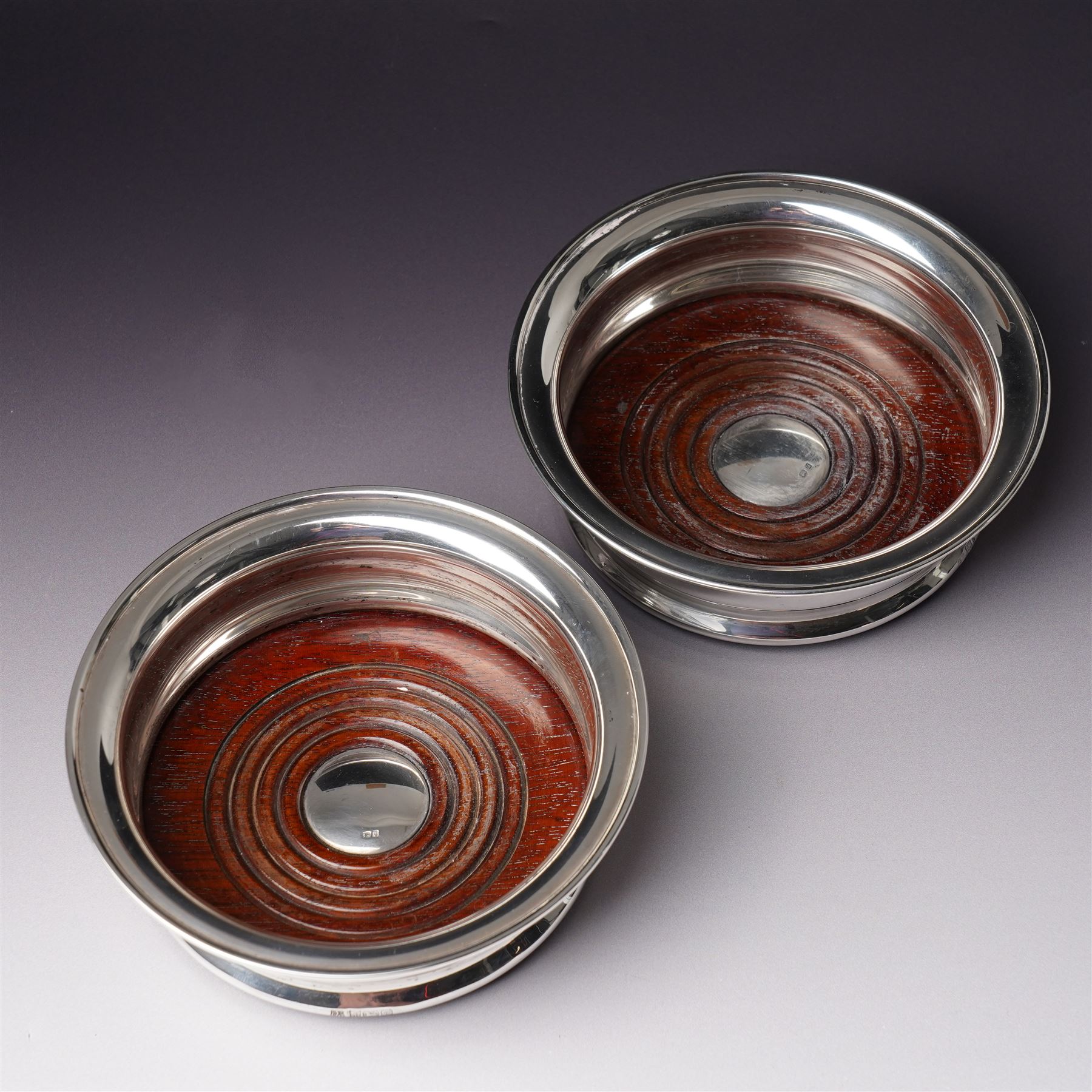 Pair of silver bottle coasters with turned wooden bases D13.5cm Birmingham 1969 Maker Barker Bros.Silver Ltd 
