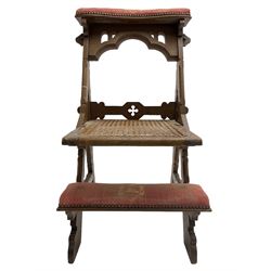 Late Victorian oak metamorphic prie-dieu chair, ecclesiastical design with pegged construction, upholstered kneel rest and top rest, hinged cane work seat