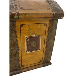 19th century painted oak sea chest, hinged dome top enclosing small compartment, bound by shaped and pressed metal strapwork, scumbled finish to resemble oak and painted with small vignettes depicting portraits and landscapes within panels, fitted with large wrought metal carrying handles, the front inscribed 'H.J.S. 1870' 