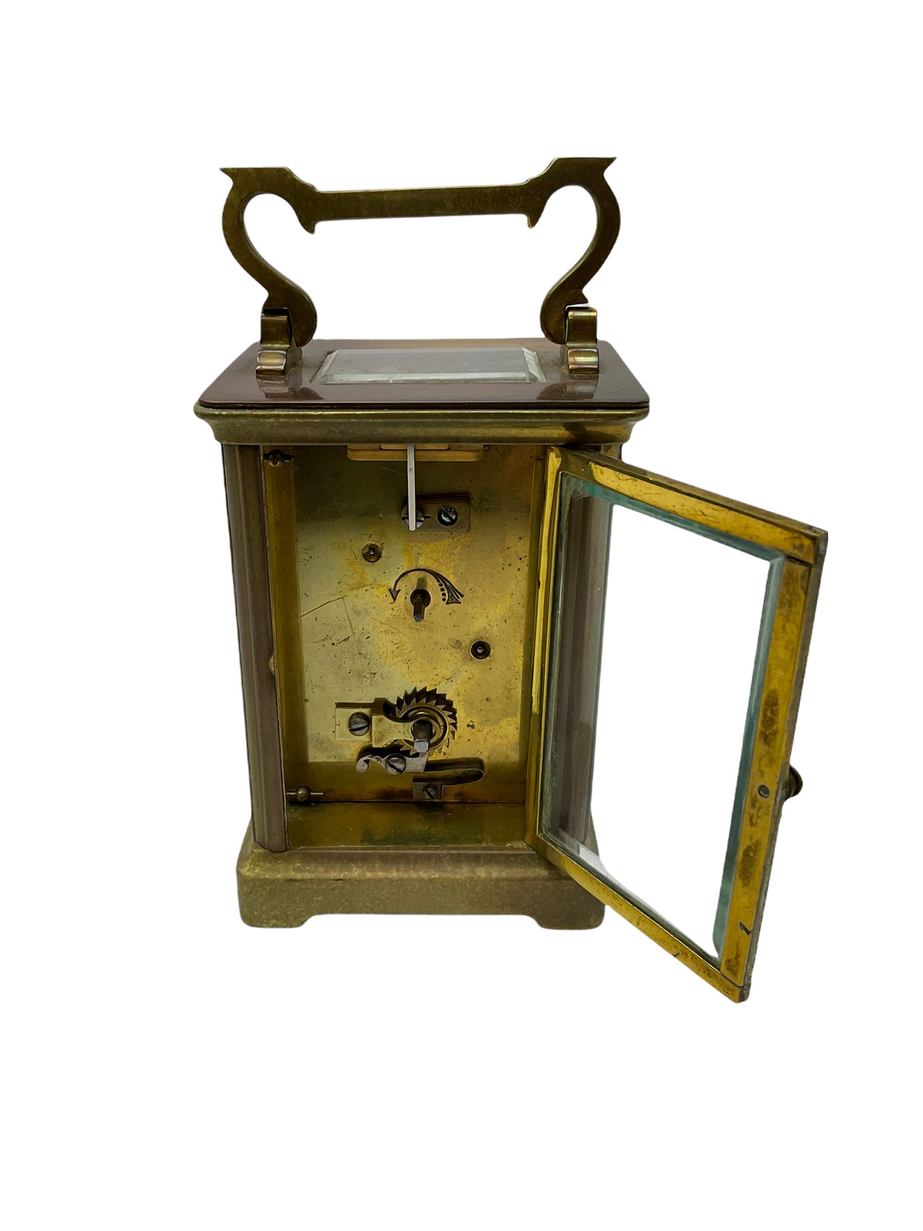 An early 20th century French timepiece carriage clock in a Corniche case with a white enamel dial , Roman numerals, decorative steel hands and minute markers, four bevelled glass panels and a rectangular panel to the top, with a replacement jewelled lever platform escapement with timing screws.