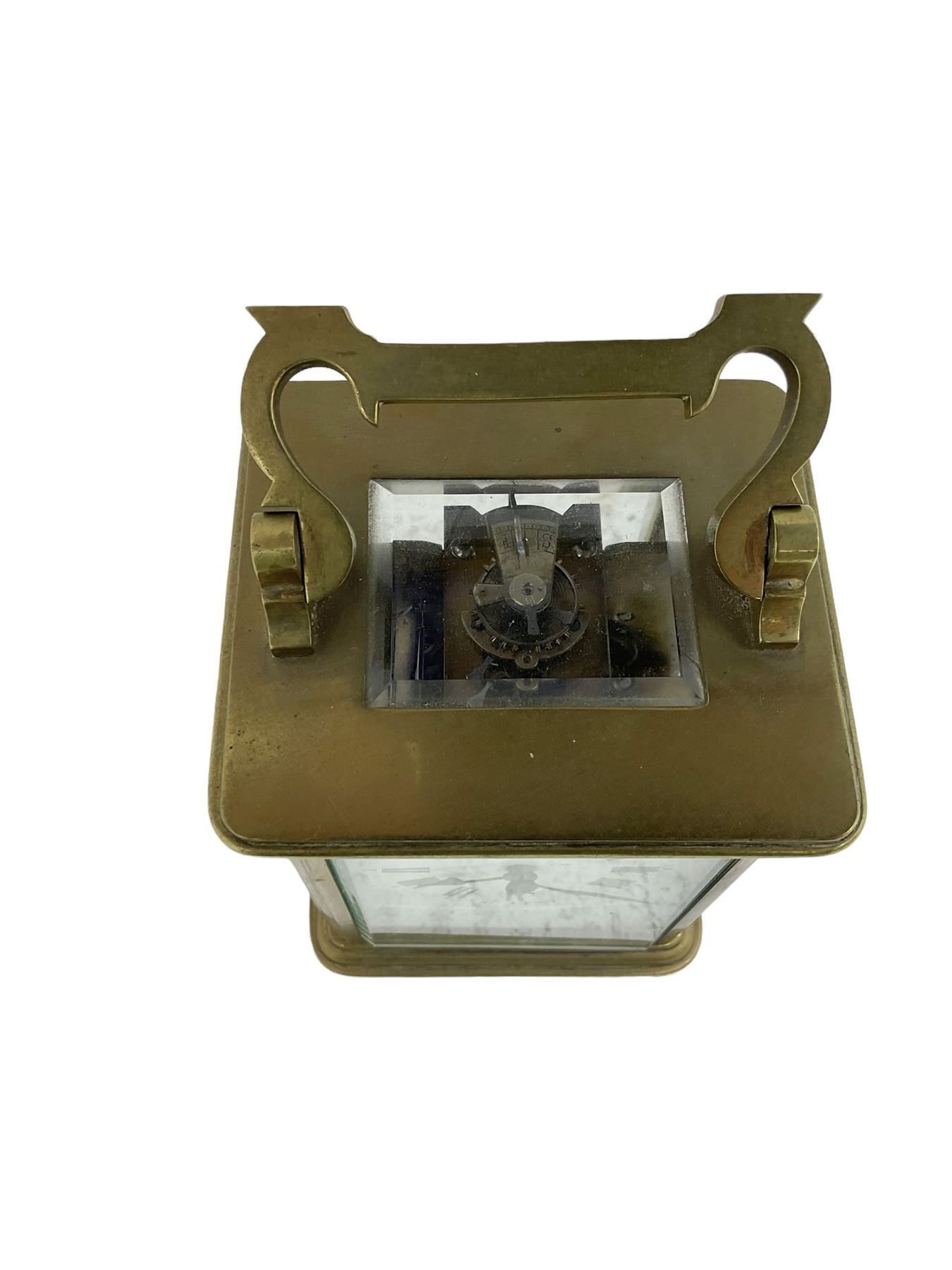 French - late 19th century 8-day carriage clock, in an Anglaise case with a rectangular glass panel to the top, enamel dial with Roman numerals, minute track and spade hands, rack striking movement, striking the hours and half hours on a coiled gong, with a lever platform escapement.  