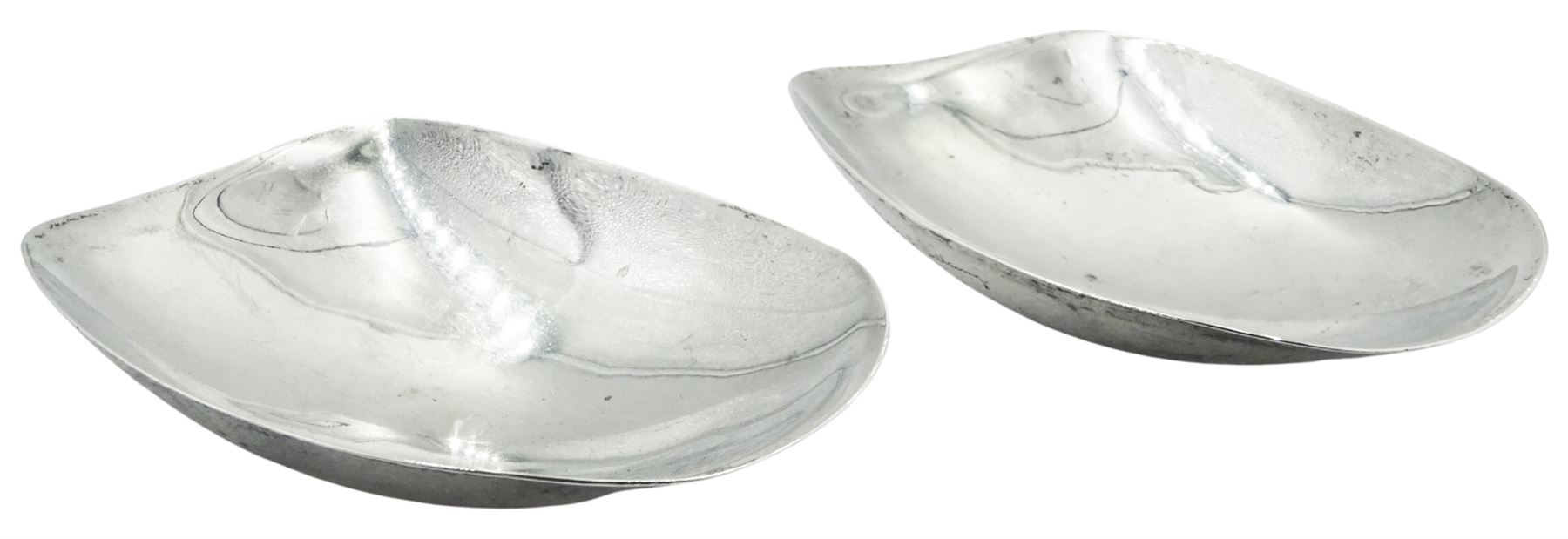 Pair of mid 20th century silver nut rocker dishes, each of curved oblong form, hallmarked Geoffrey Guy Bellamy, London 1957, W10.5cm, approximate weight 3.21 ozt (100 grams)