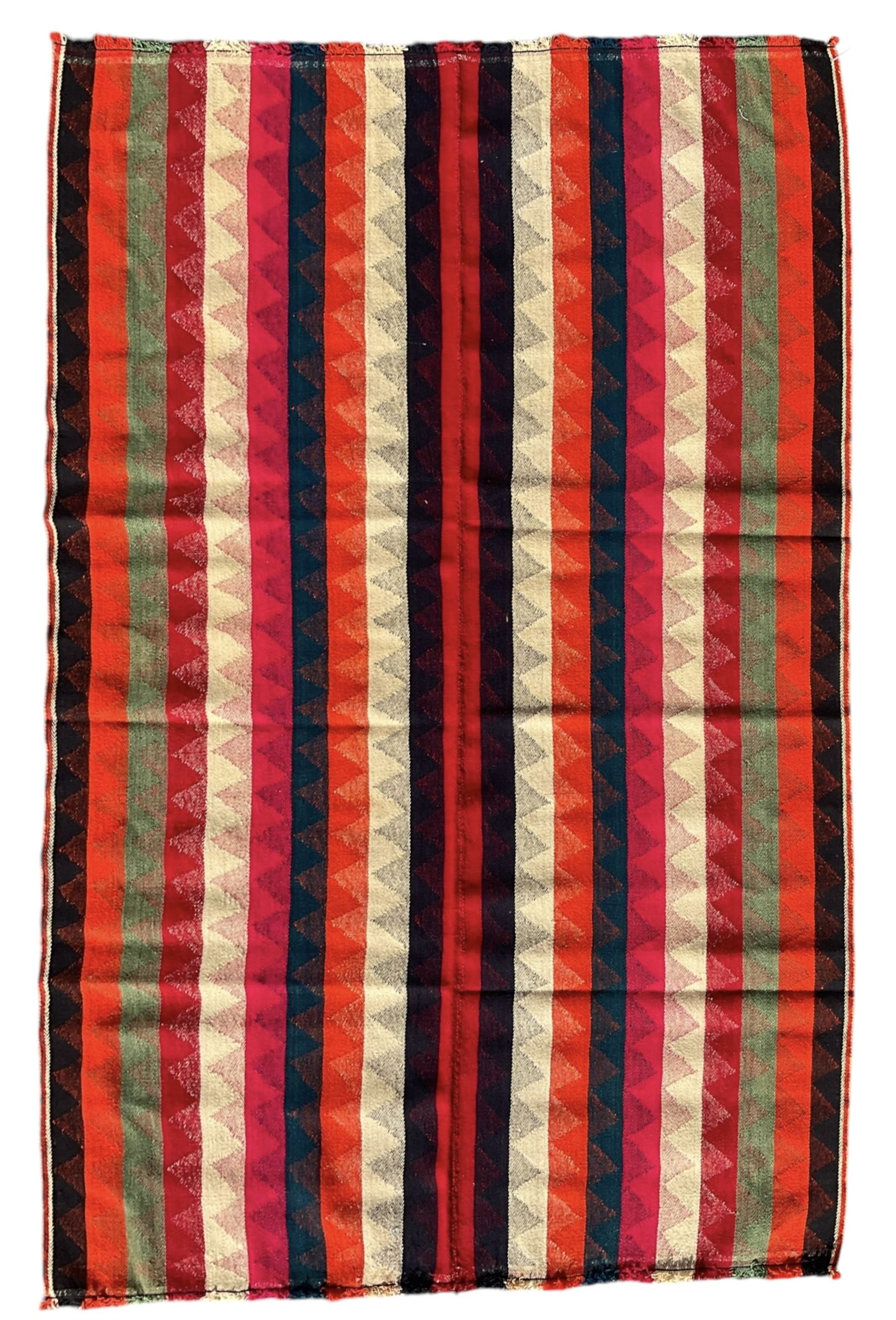 Southwest Persian Jajim Kilim ground rug, decorated with alternating vertical stripes in shades of crimson, orange, green, and black, with subtle triangular motifs woven into each stripe, bordered by narrow bands