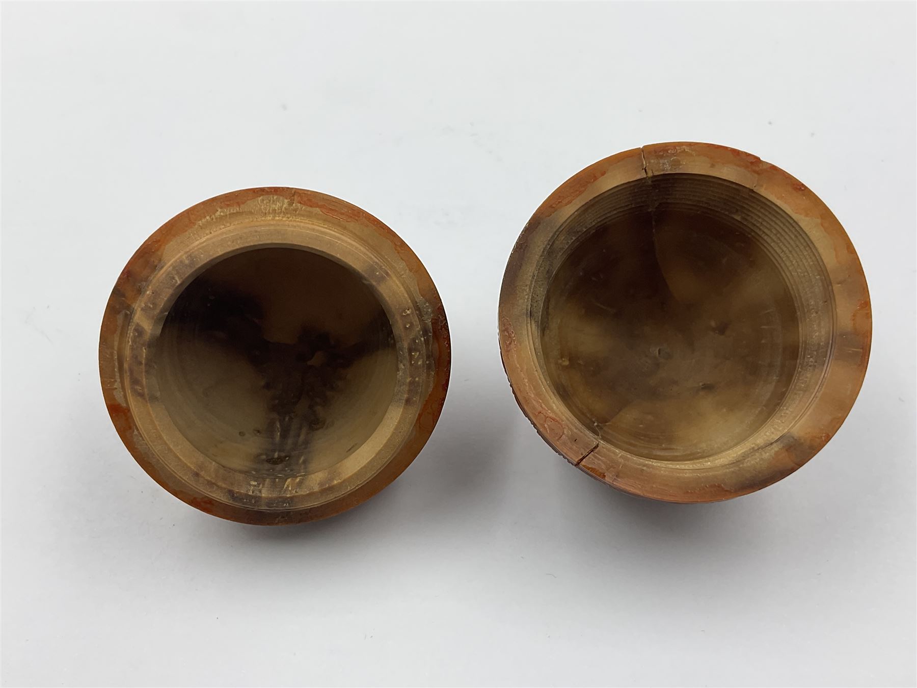 Three 19th century coquilla nut pomanders or flea catchers, two of egg shaped form and the third of barrel from with carved and pierced decoration and screw threaded join, largest H8cm