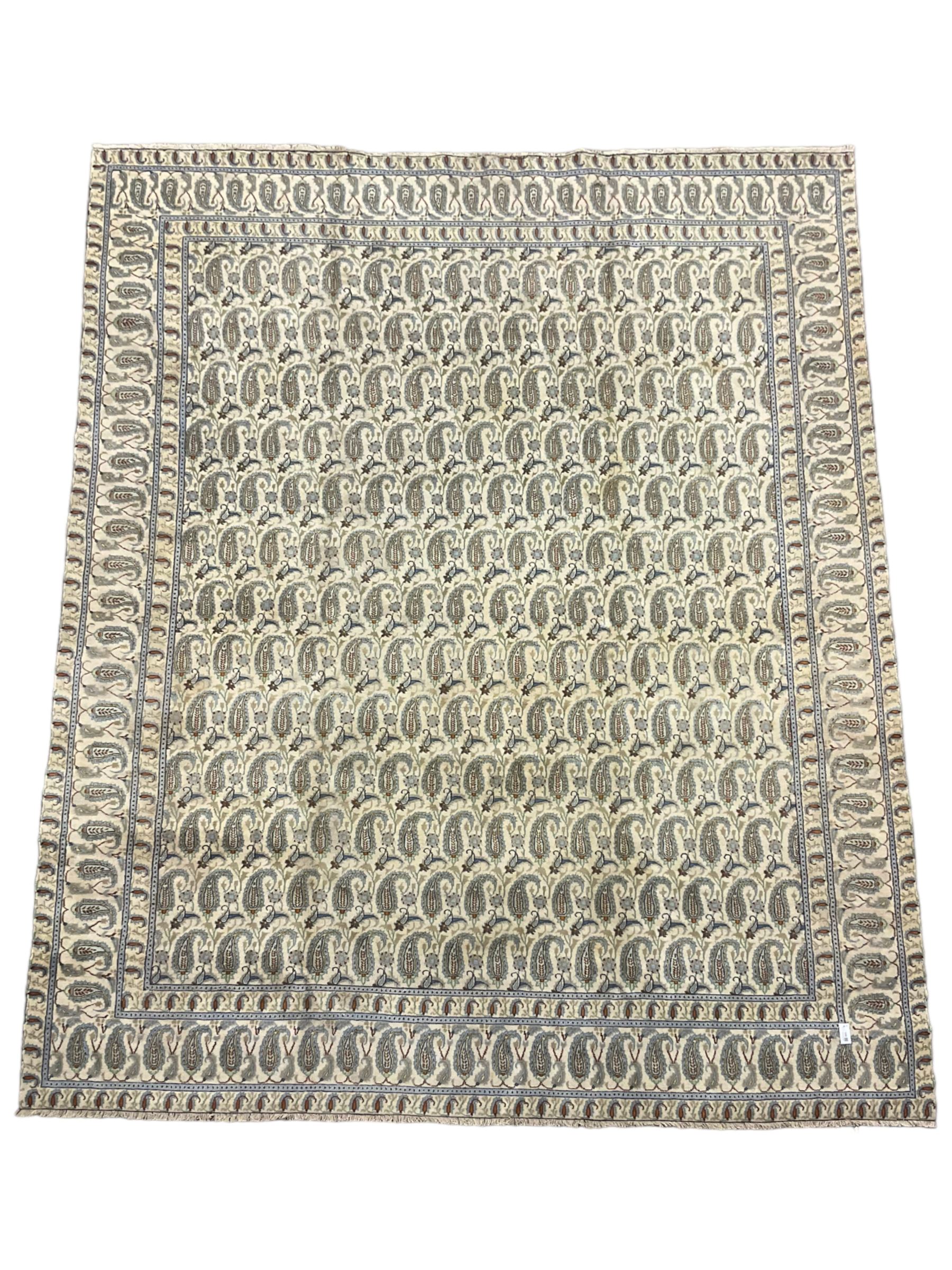 Central Persian Kashan ivory ground carpet, decorated with repeating Boteh motifs, the three band border decorated with further Boteh motifs