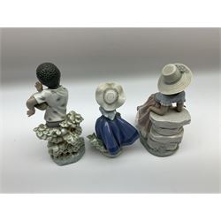 Pair of Lladro figures designed by Jose Roig, Bongo Beat no. 5157 and A Step in Time no. 5158 and a Lladro figure of a girl with a basket of flowers.
