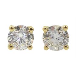 Pair of single stone round brilliant cut diamond stud earrings, stamped 750, total diamond weight approx 0.70 carat