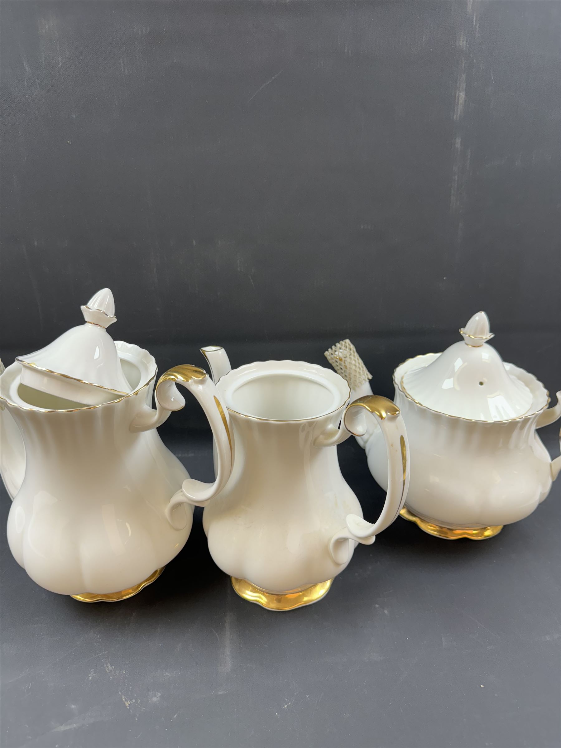 Royal Albert Val D'or part tea and dinner service, including two coffee pots, two teapots, milk jug, covered sucrier etc together with matching items 