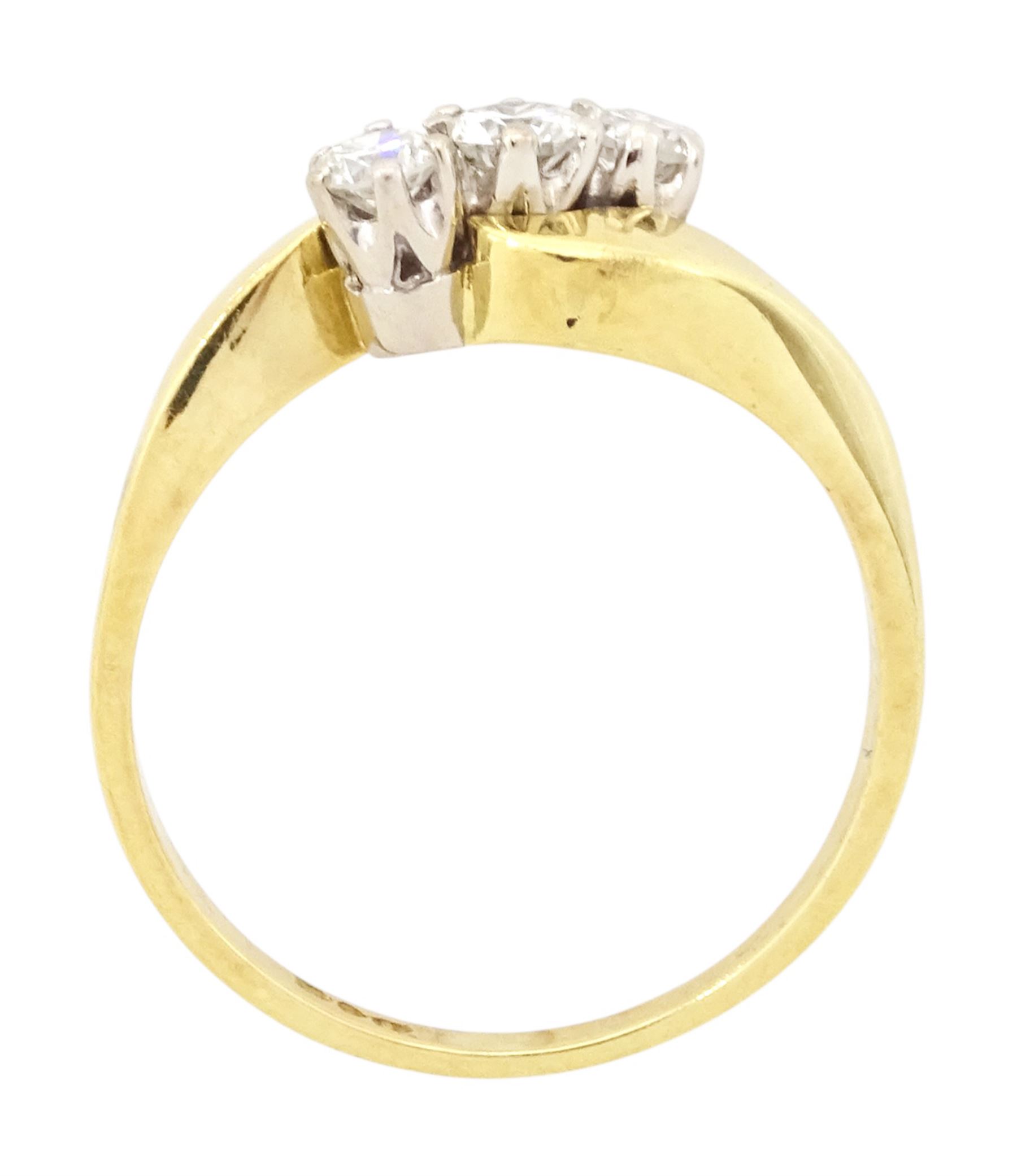 18ct gold diamond crossover ring, set three round brilliant cut diamonds, London 1991, total diamond weight 0.35 carat