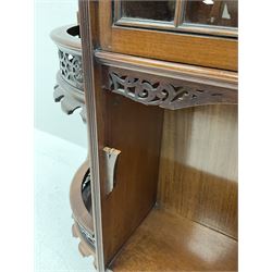 Mahogany wall hanging cabinet with carved detail, two glazed doors, above two shelves 
