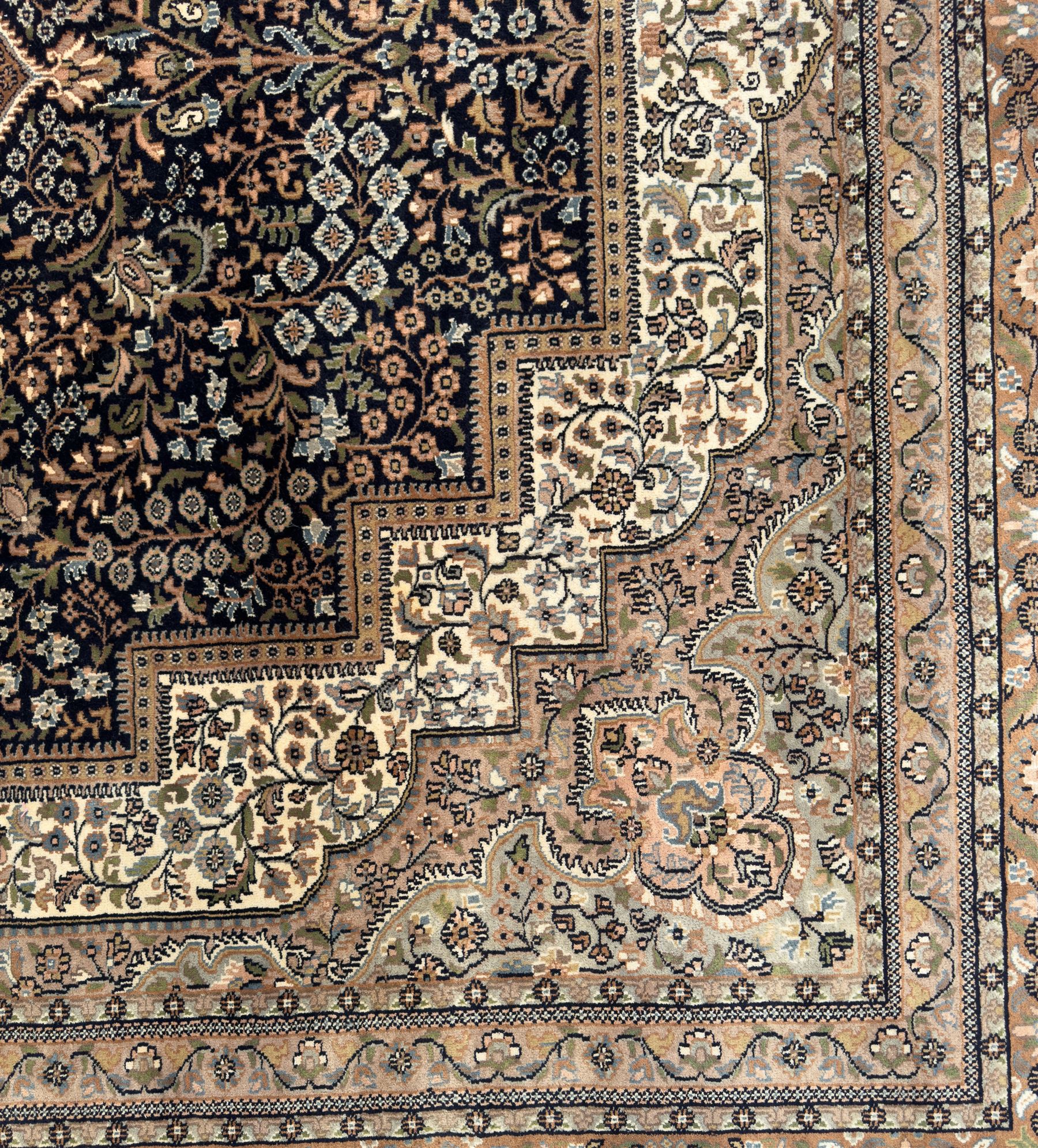 Large Persian indigo ground rug, the busy field decorated with trailing branches and flower heads, peach border decorated with palmettes -