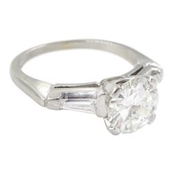 Platinum round brilliant cut single stone diamond ring, with tapered baguette diamond shoulders, central round diamond approx 1.70 carat
