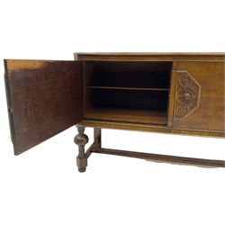 Early to mid-20th century oak two door sideboard, decorated with applied mouldings and octagonal foliage scrolled mount
