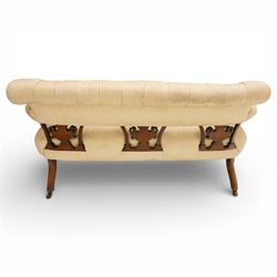 Edwardian inlaid mahogany sofa, upholstered in cream fabric with buttoned back rail, tapering legs on brass castors