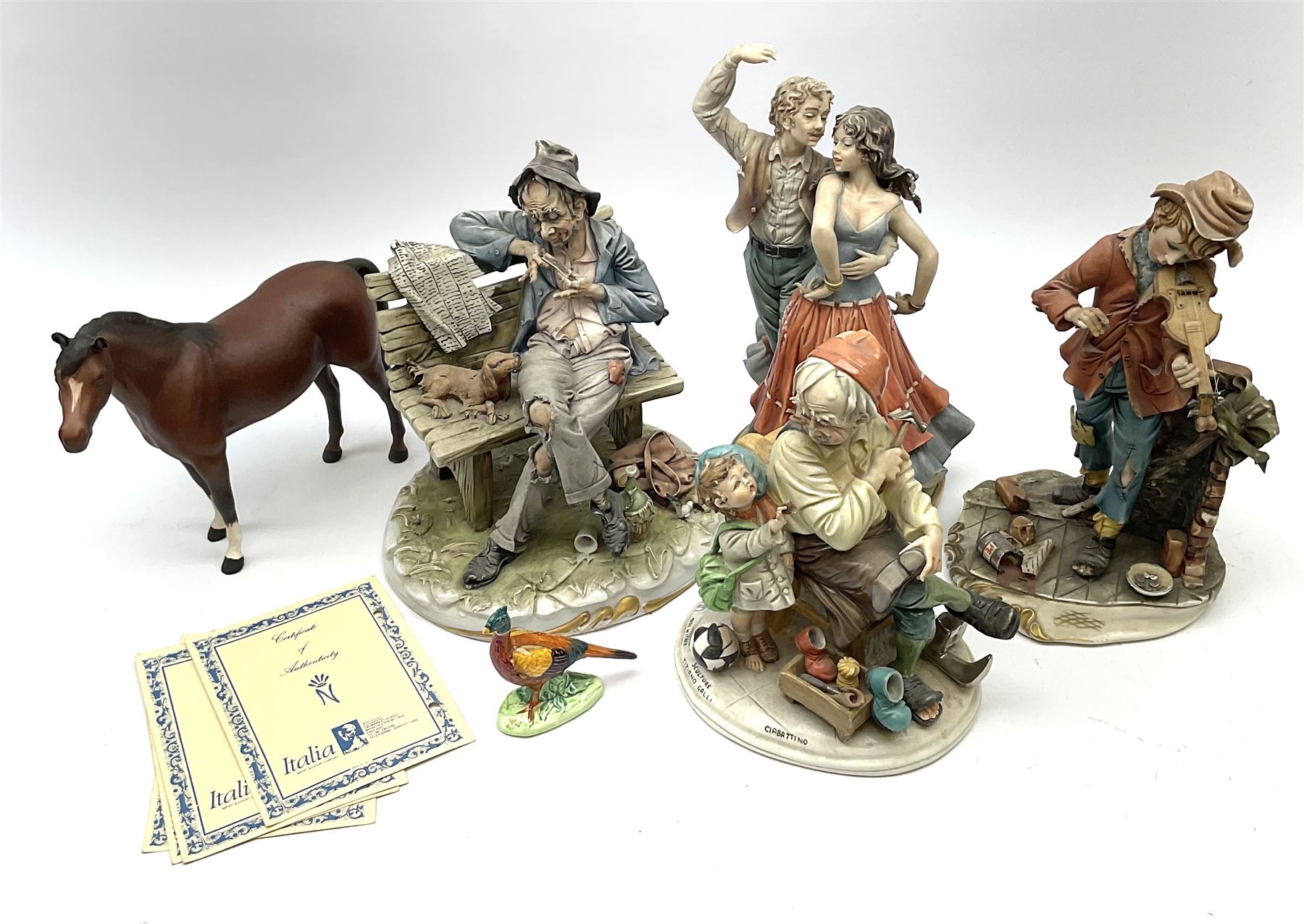 Four Capodimonte figures, comprising Shoemaker by T Galli, Tramp on Bench by Roby B, The Fiddler by Maria Angela, and Gypsy Dancers by Sandro, each with accompanying certificate, plus a Beswick matt glazed horse, and small Beswick pheasant. 