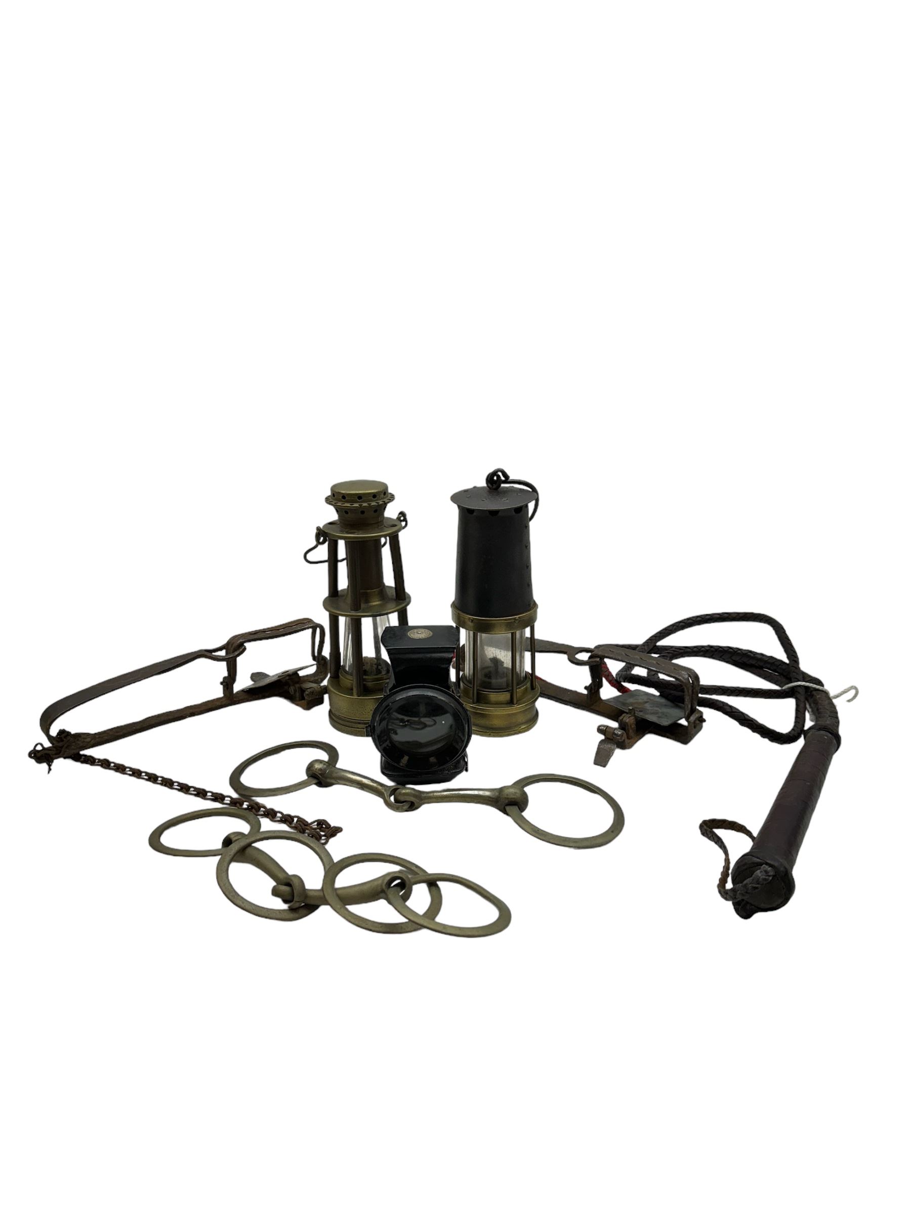 Two miners lamps, together with animal traps, bull whip etc 