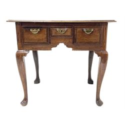18th century oak lowboy, moulded rectangular top over three drawers with mahogany band and stringing, the central drawer pulls out to reveal deeper hidden drawer, shaped apron with fluted upright decoration, on cabriole supports