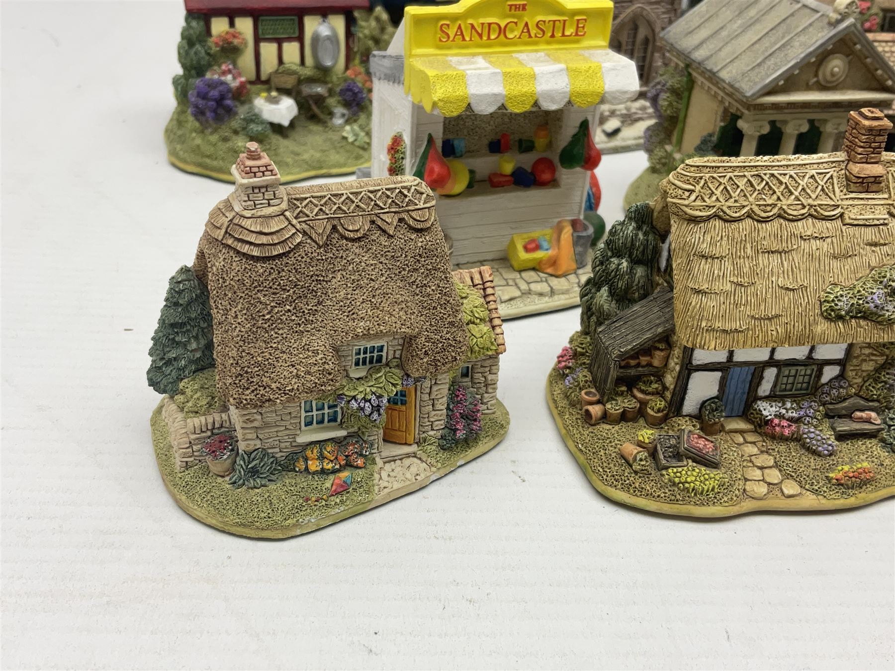 Eighteen Lilliput Lanes, including The Penny Farthing, The Pigsty, Borrowdale School, Fairy Cake Tearoom, An Apple a Day,Ladybird Cottage etc, all with original boxes 