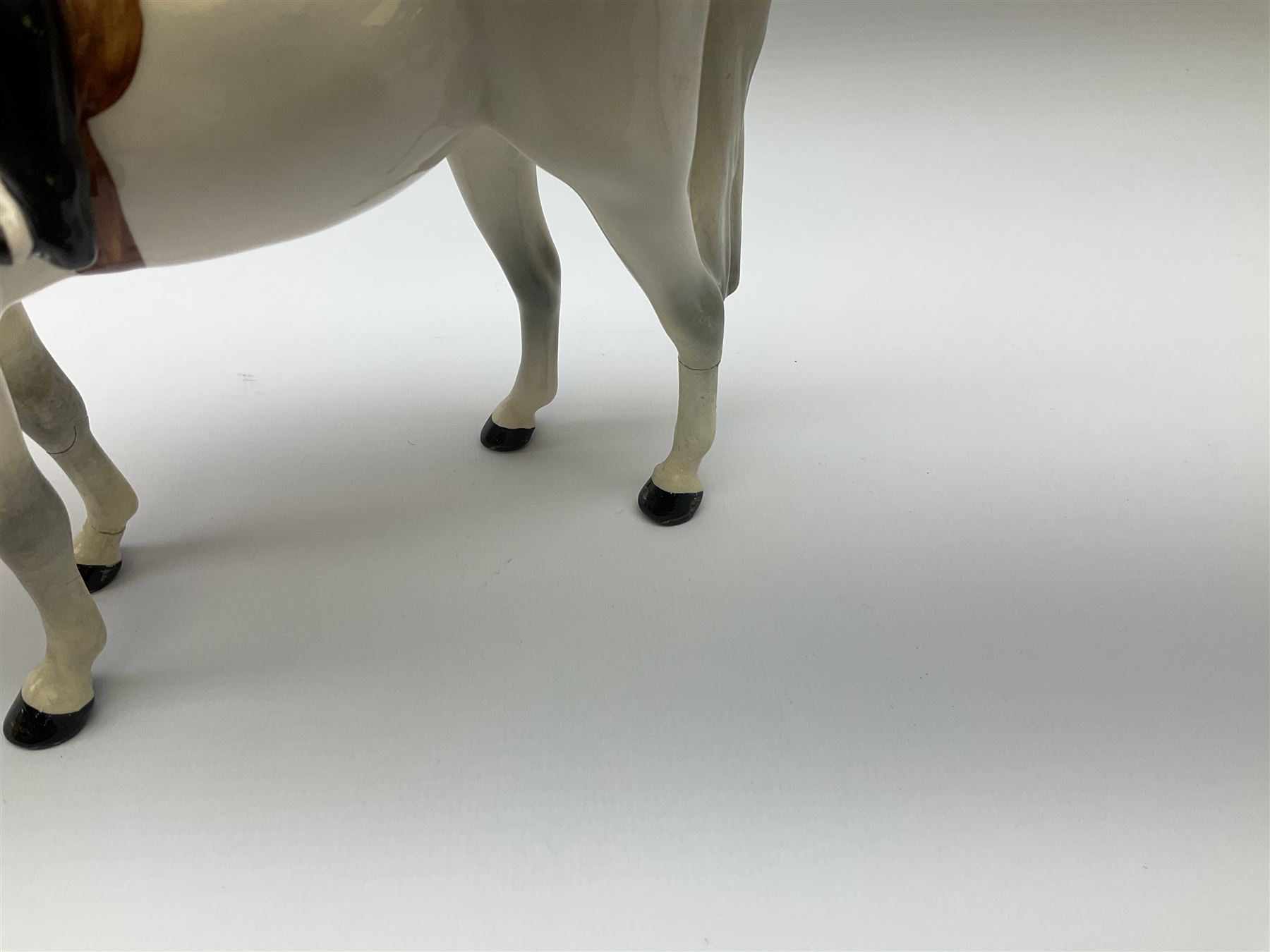 Beswick model of a huntswoman on grey horse model no 1730, and Beswick huntsman on brown horse model no 1501, both with printed mark beneath. 