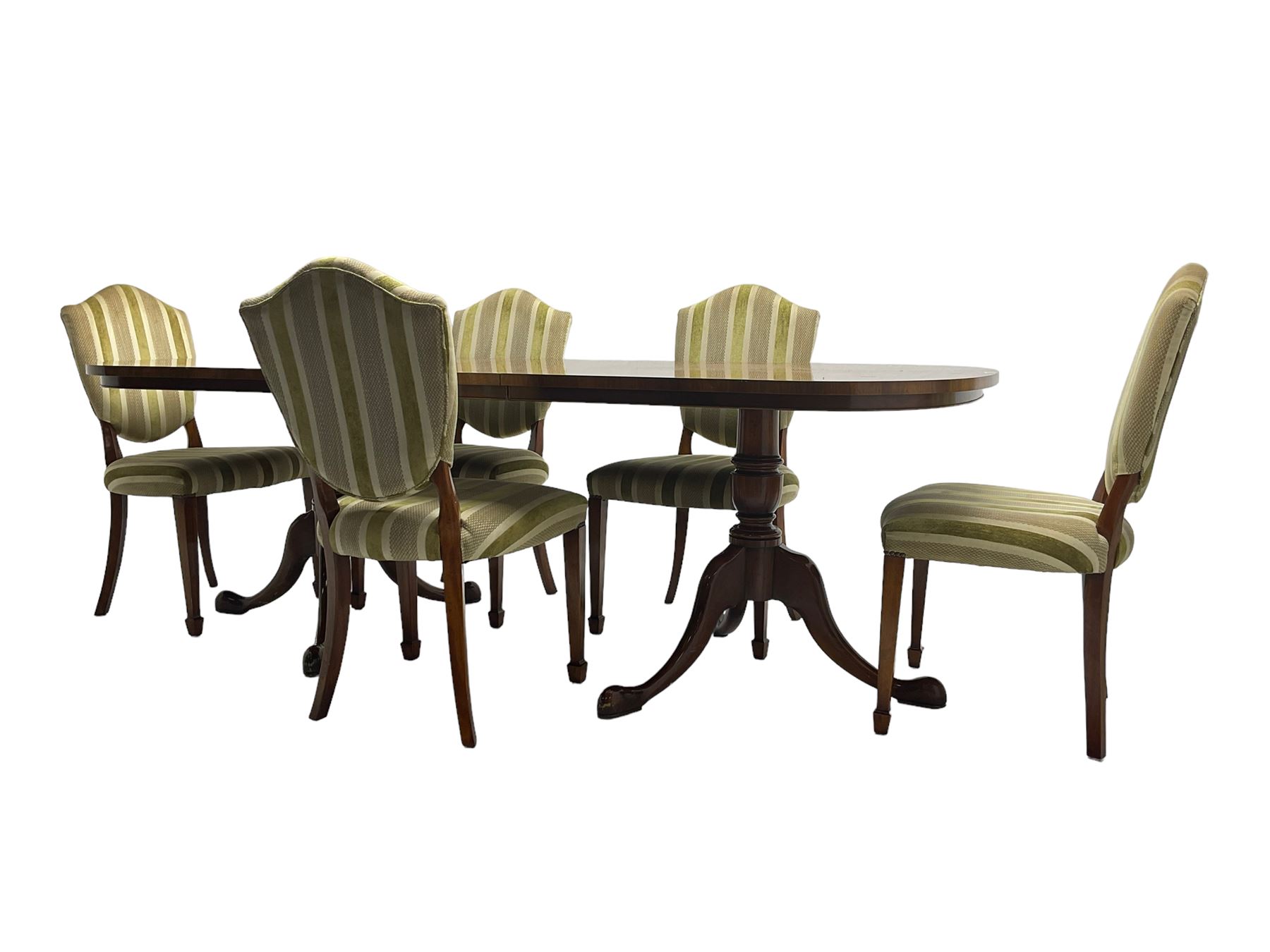 Regency design walnut twin pedestal extending dining table, rectangular burr top with rounded corners and crossbanding, raised on turned vasiform columns with tripod base, with additional leaf (D107cm W184cm/230cm, H76cm); and set eight (6+2) shield back dining chairs, upholstered in striped laurel green fabric, raised on tapering supports with spade feet, retailed by Geoffrey Benson