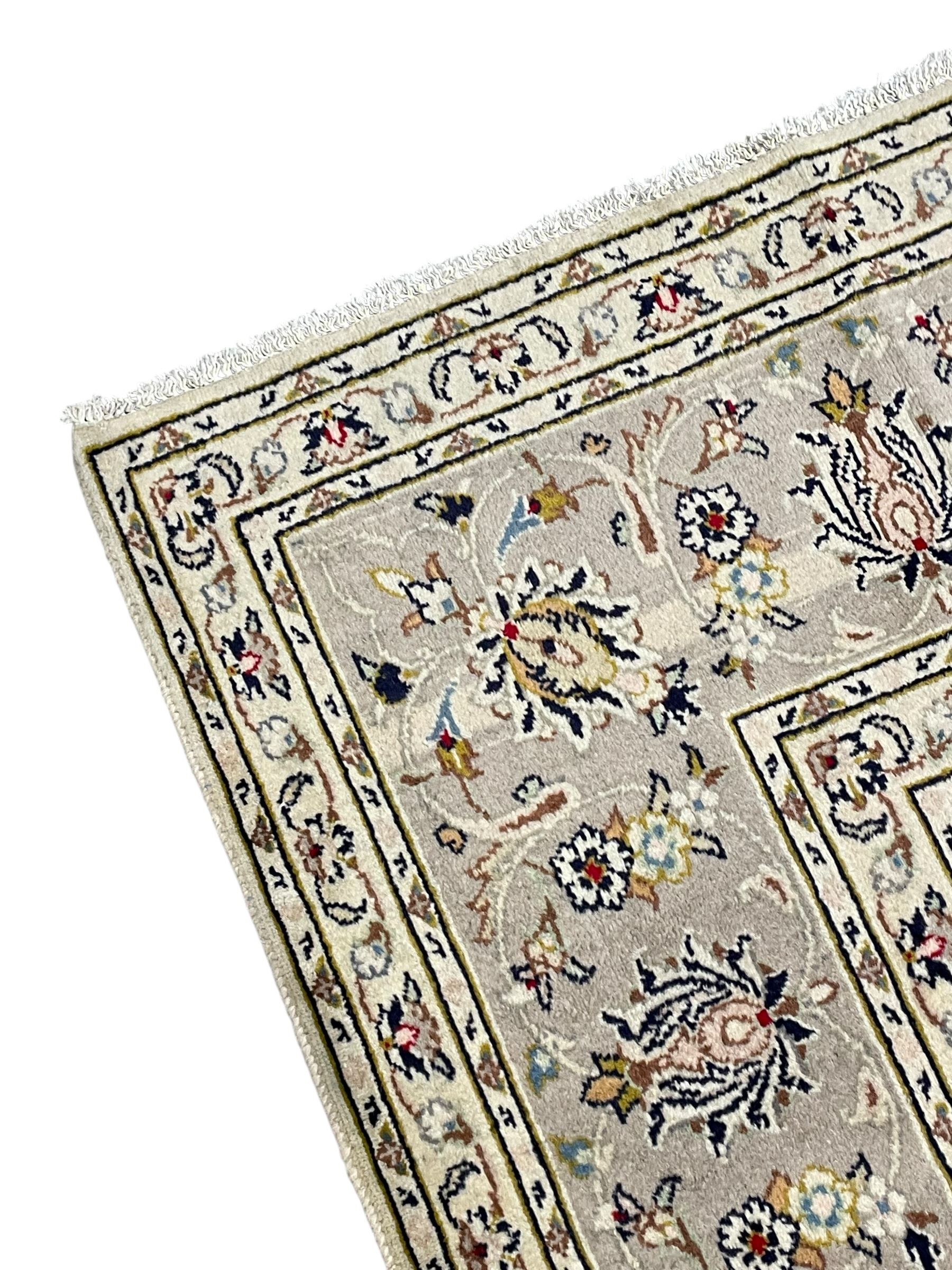 Persian Kashan ivory ground carpet, floral central medallion surrounded by trailing leafy branches and palmettes, floral pattern spandrels and matching border, within guard stripes