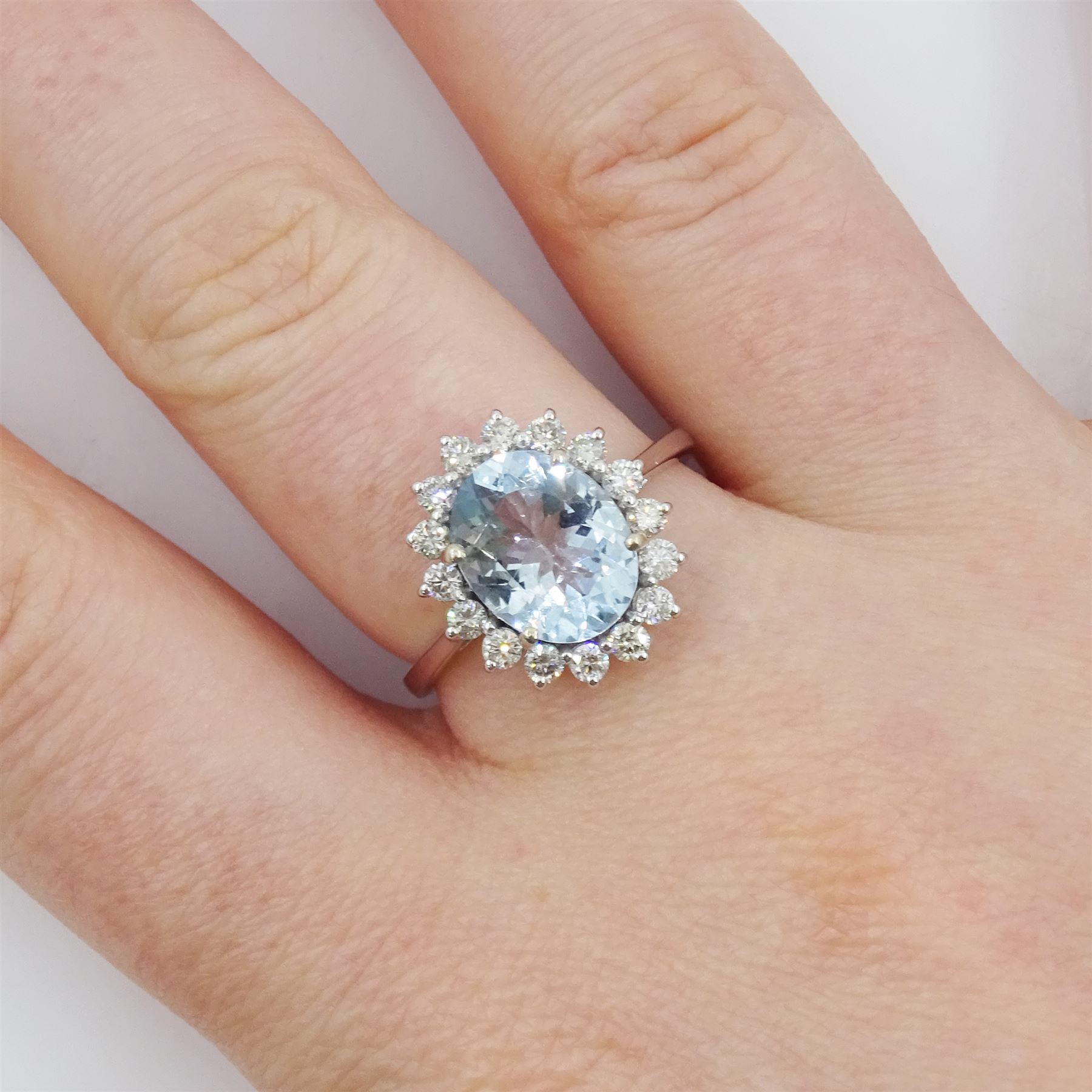 18ct white gold oval cut aquamarine and round brilliant cut diamond cluster ring, aquamarine approx 2.15 carat, total diamond weight approx 0.50 carat
