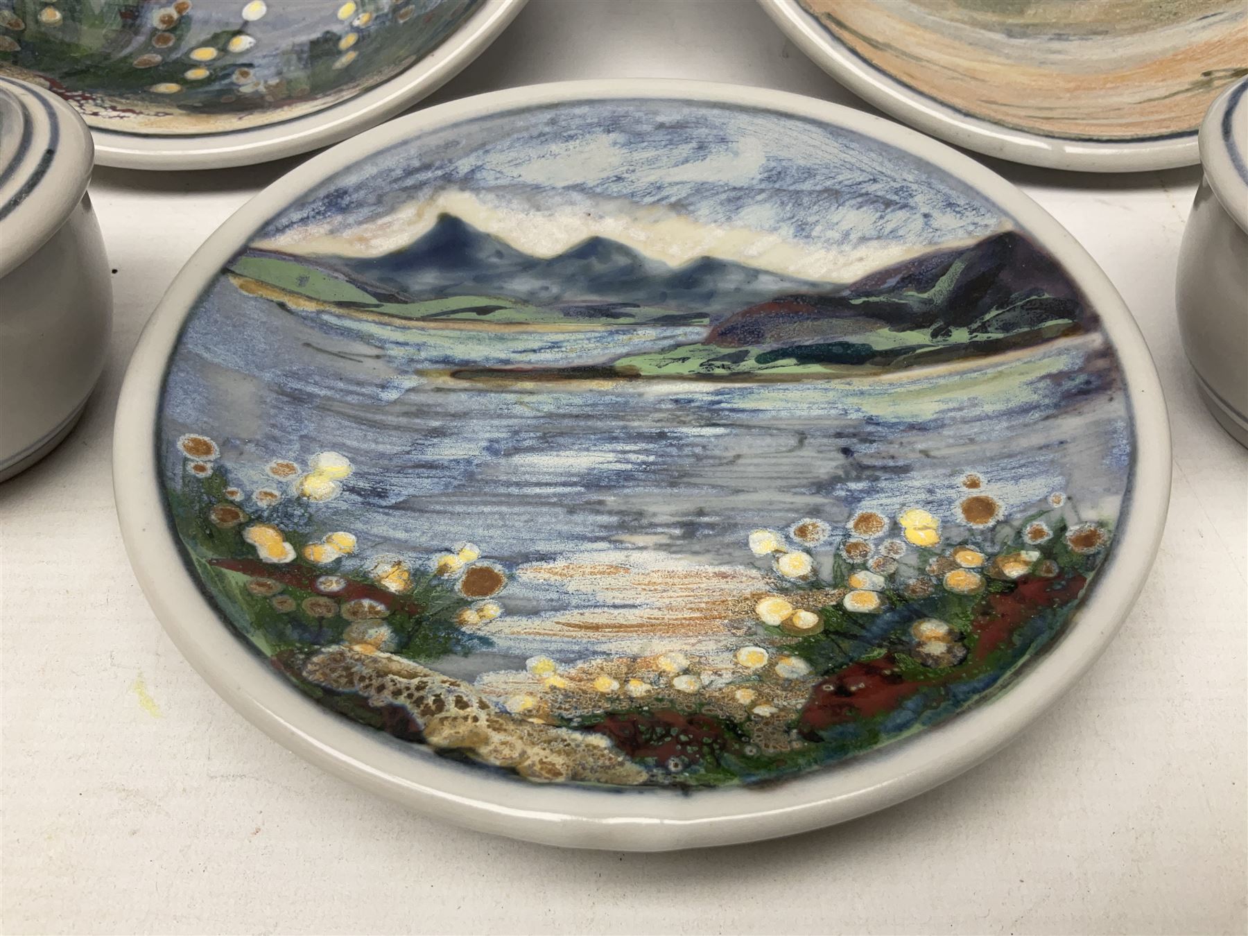 Highland Stoneware Scotland, decorated with landscapes and seascapes, comprising of two bowls, plate and two covered trinket boxes 