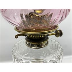 20th century Hawksworth, Eyre & Co silver plated oil lamp, the octagonal stepped base with engraved dedication, leading to an octagonal column supporting a faceted clear glass reservoir, Hinks Duplex burner, clear glass chimney, and cranberry glass shade, overall H71.5cm