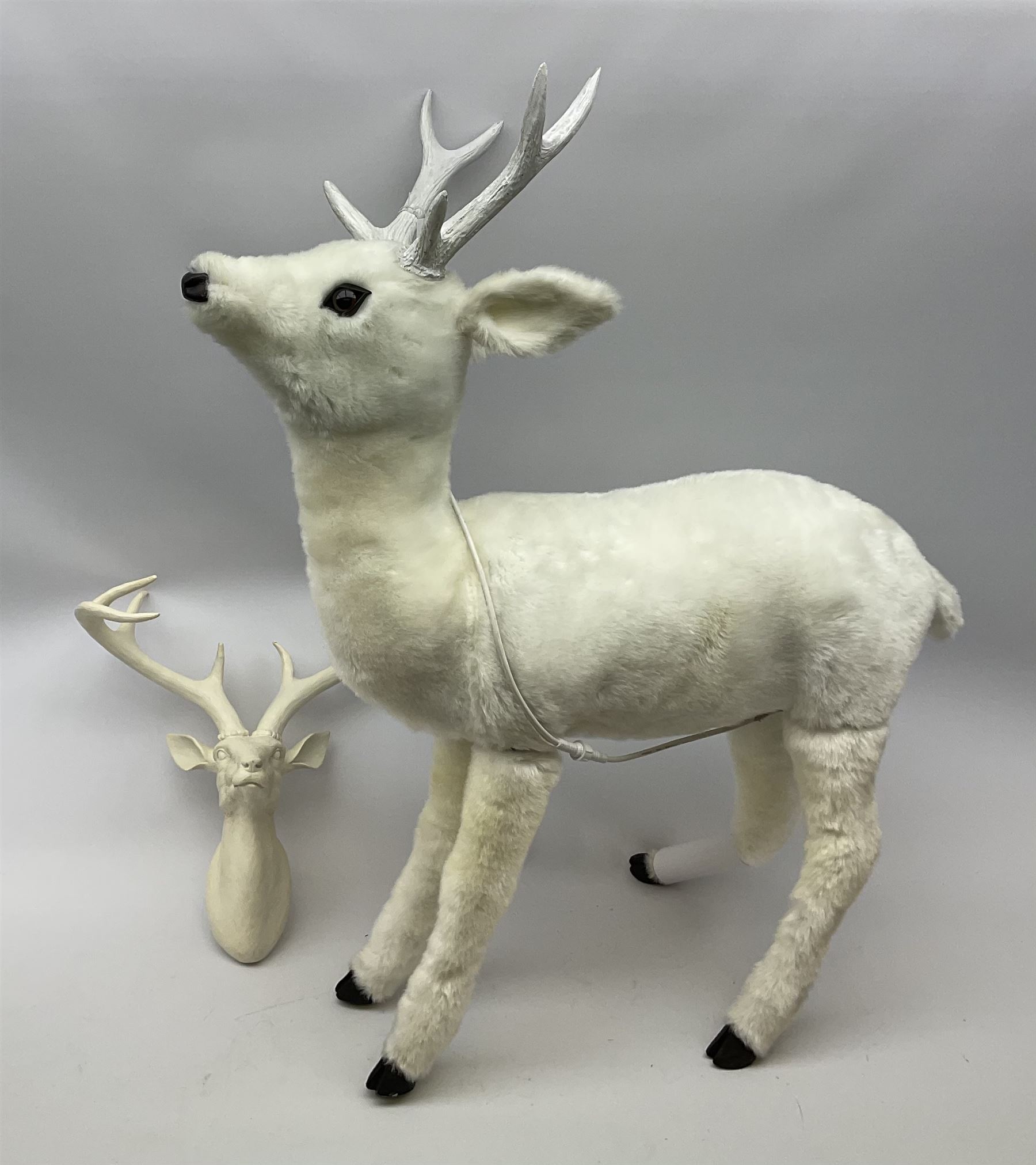 An electronic moving reindeer, H101cm, together with a pair of composite antlers. 