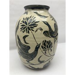 John Egerton (c1945-): studio pottery stoneware vase decorated with birds in flowers braches upon a white ground, H40cm