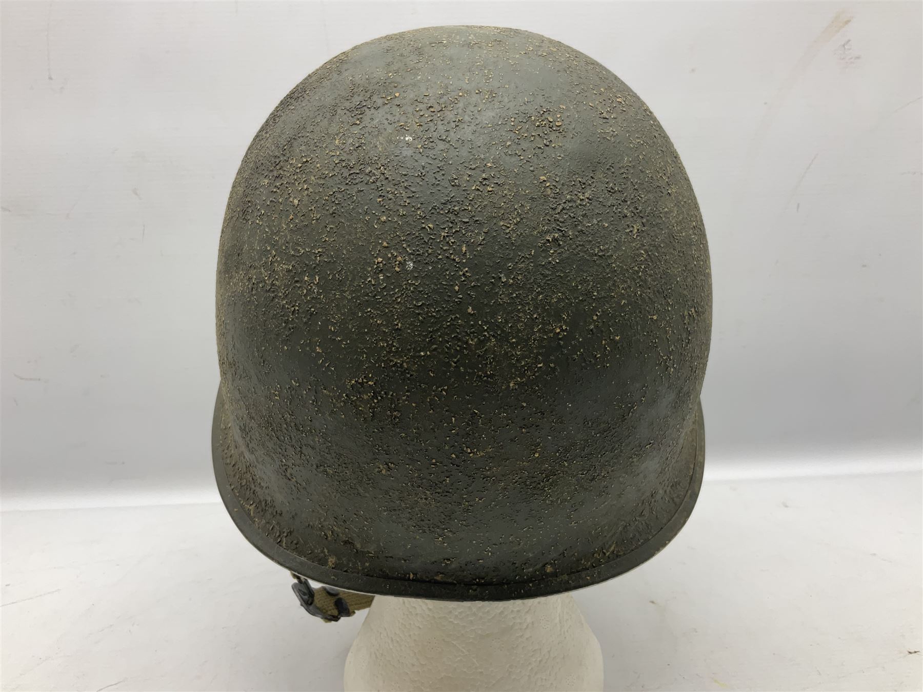 American first type paratrooper helmet with post-WW2 strap and D-rings and later 1944 liner bearing Firestone Tyre and Rubber Company mark; green textured finish