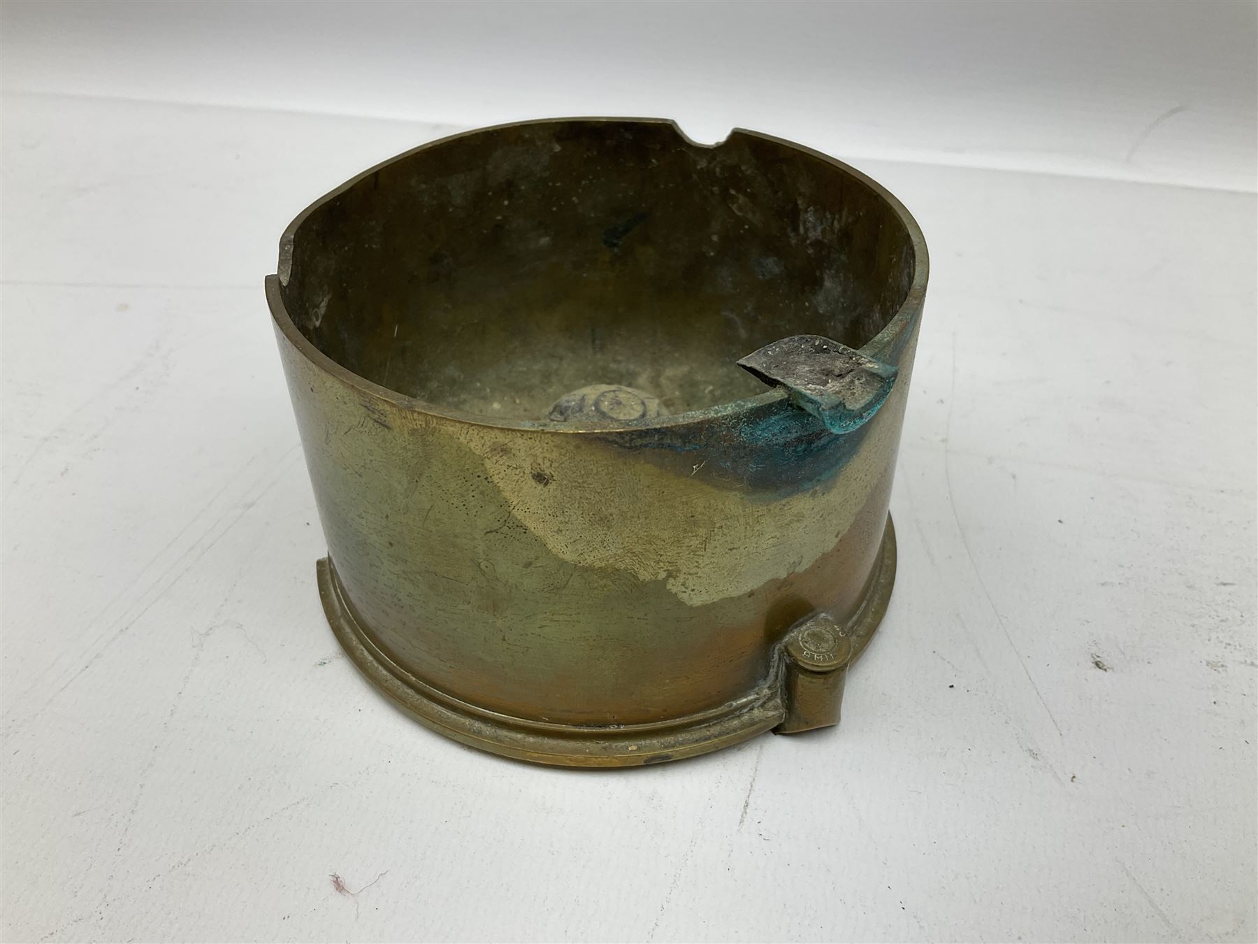 Trench Art - three WW2 brass shell case ashtrays, one mounted with Royal Artillery cap badge and button and one mounted with RA button; together with a pair of place name holders each formed from a Royal Artillery cap badge (5)