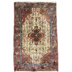 Small Persian rug, ivory and pale red ground, decorated with central medallion within a field of trailing Boteh motifs, geometric design guarded border