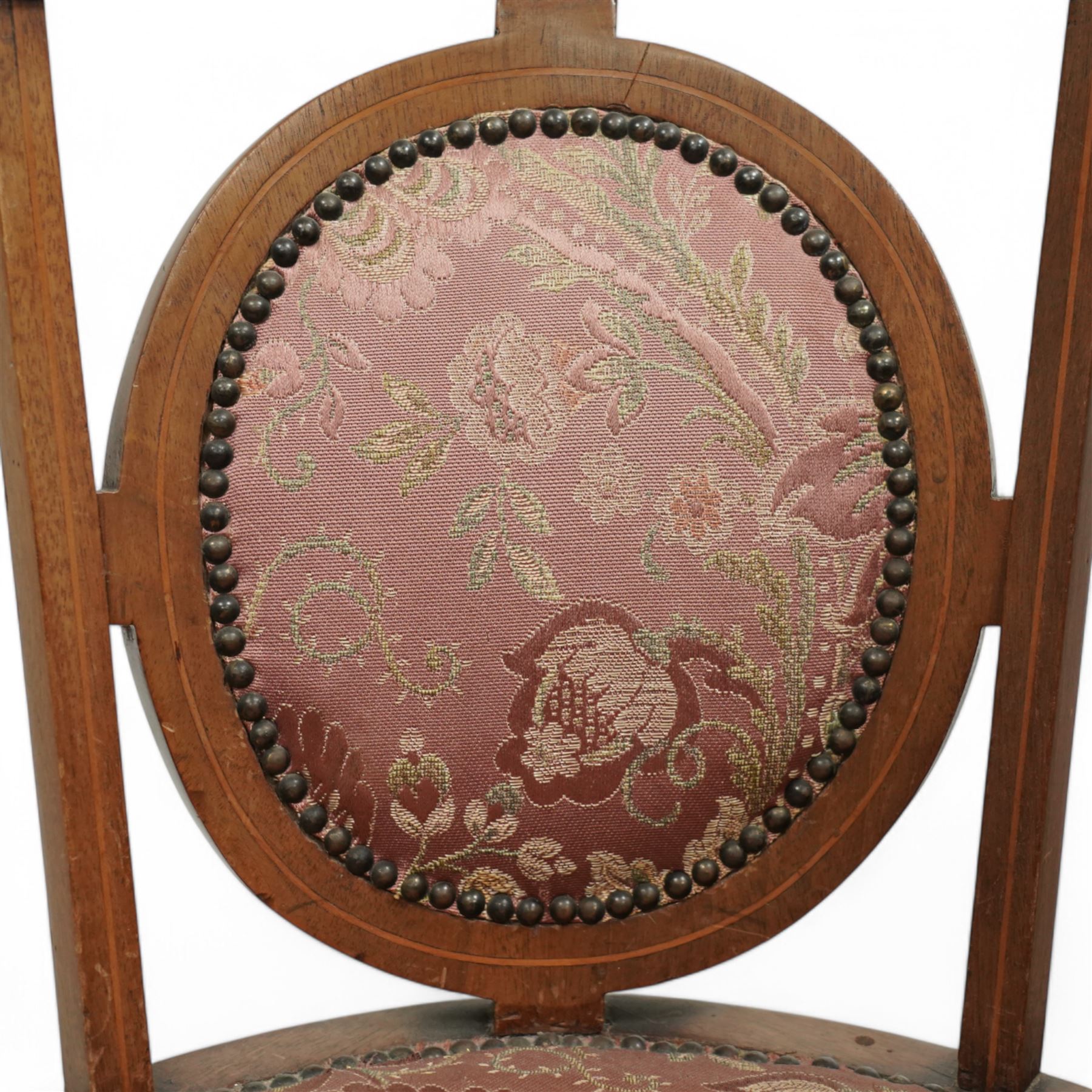Edwardian inlaid mahogany corner chair, shaped cresting with satinwood band over interlaced splats, upholstered in floral pattern fabric, on square tapering supports with spade feet united by X-stretcher 
