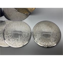 Set of eight silver plated placemats, each of circular form with engraved scroll and floral decoration, including two larger and six smaller examples, largest D23cm, in fitted case 