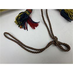 Two military brass bugles by Mayers and Harrison Ltd. Manchester each with crows foot mark and dated 1966; both with multi-coloured cord and tassels, longest 52.5cm (2)